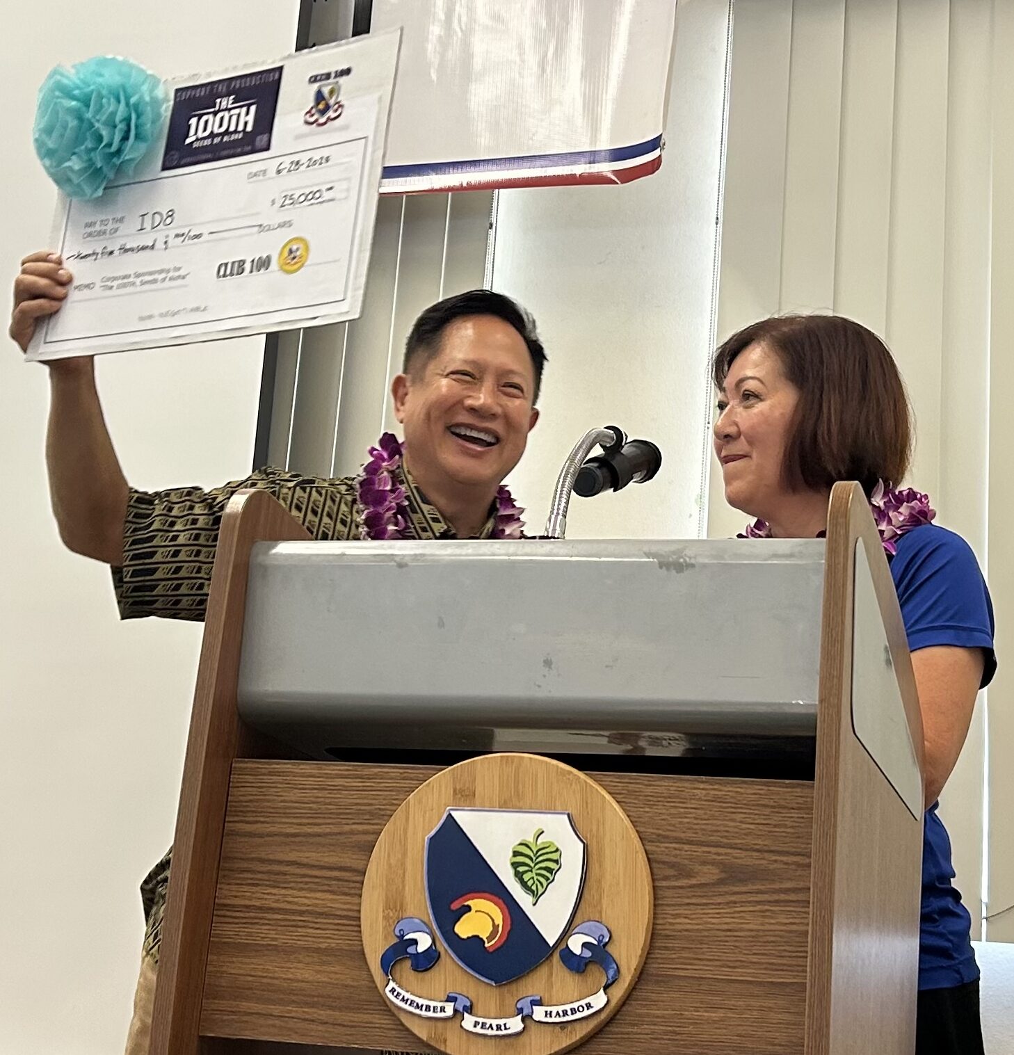 Steve Sue receives $25,000 from Club 100ʻs Kathi Hayashi for THE 100th, Seeds of Aloha.